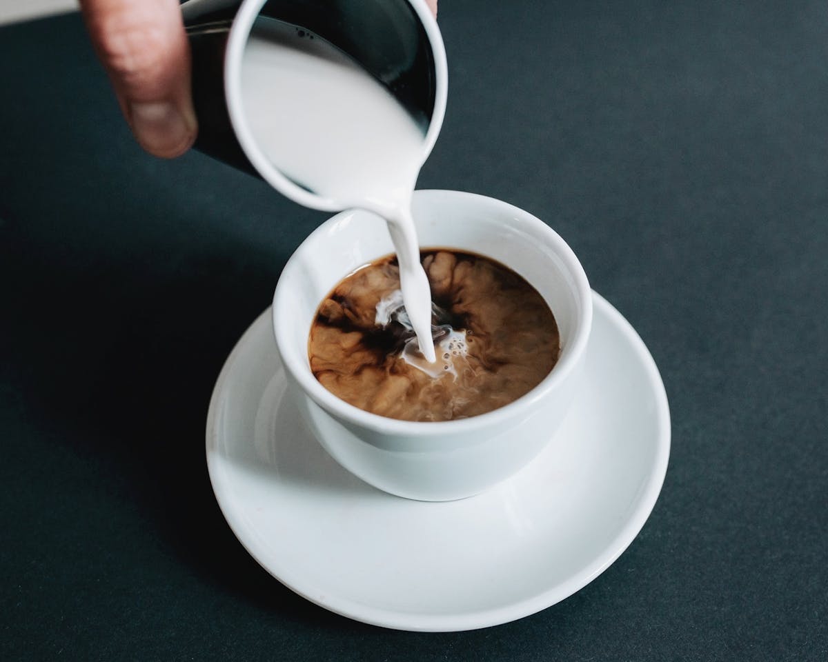 Pouring coffee creamer