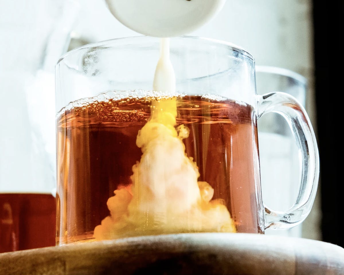 Pouring cream into coffee